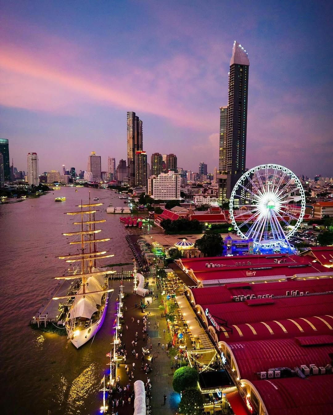 Asiatique The Riverfront in Bangkok with riverside skyline and illuminated evening view