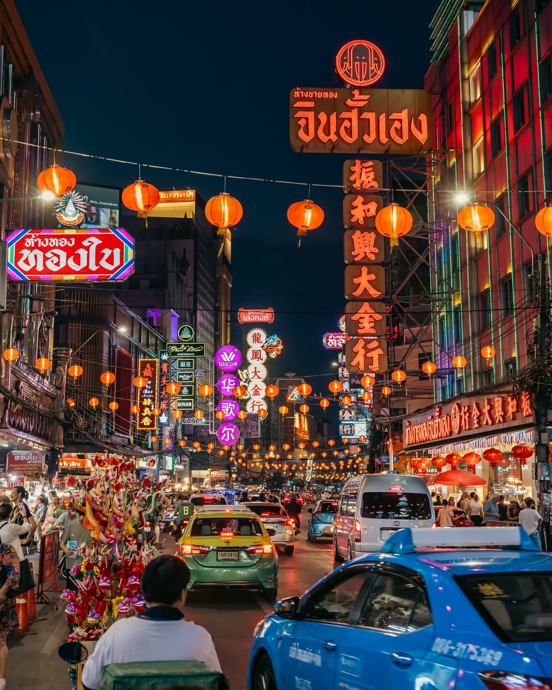 Chinatown Night Market in Bangkok with lantern-lit streets and lively evening traffic